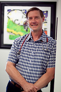 Physician standing in doorway.